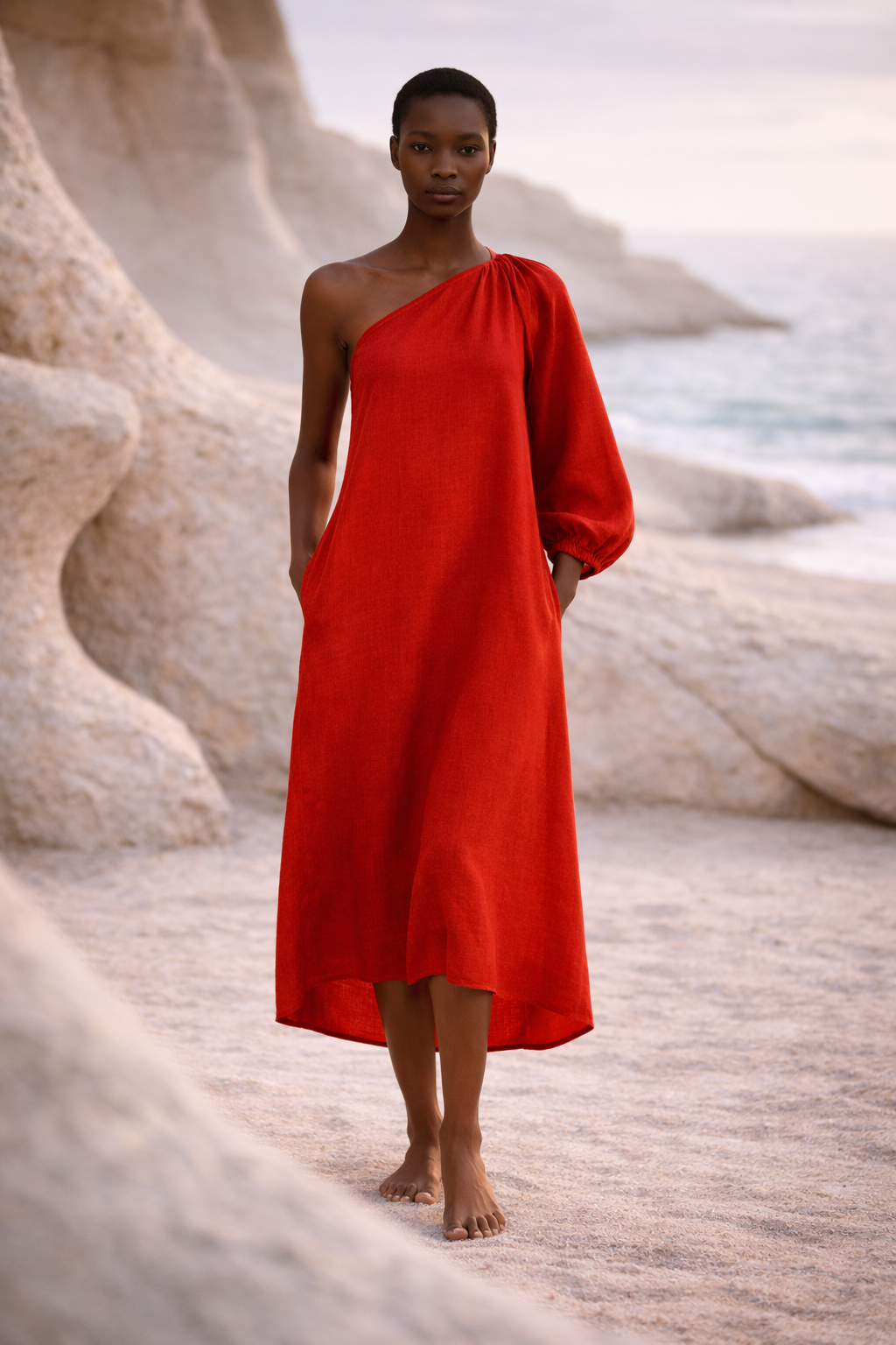 Supermodel wearing red one-shoulder midi dress with pockets on the seaside by MOBORR 

